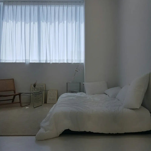 A bedroom with a bed and a chair in it