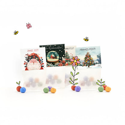 Kleine Weihnachtsgeschenke mit 12 Tütchen Blumenmurmeln in vier Weihnachtsmotiven